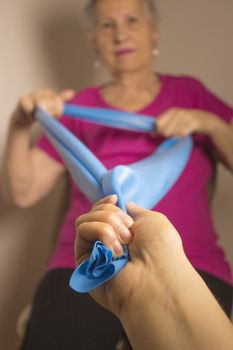 Rehabilitation exercises for older women with elastic band