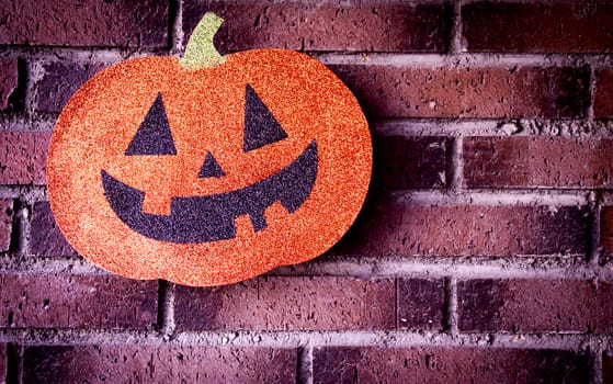 Pumpkin with face drawn for halloween.