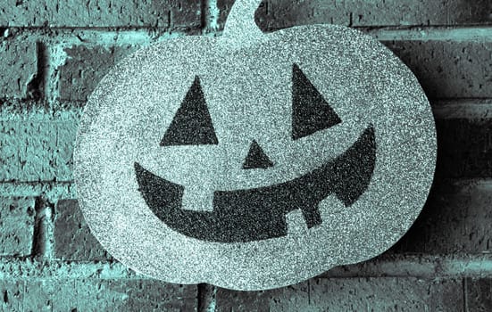 Pumpkin with face drawn for halloween.