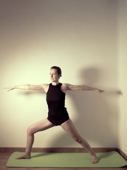Individual yoga practice performed by a woman