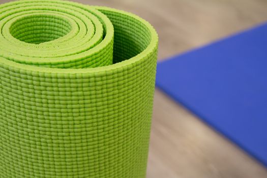 Yoga mat on wooden floor to perform meditation exercises