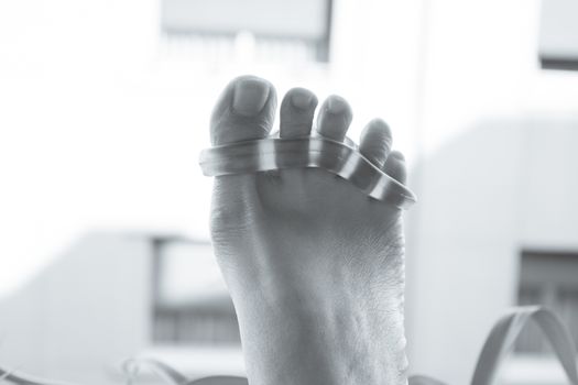 Separator for the toes. Stretching exercise.