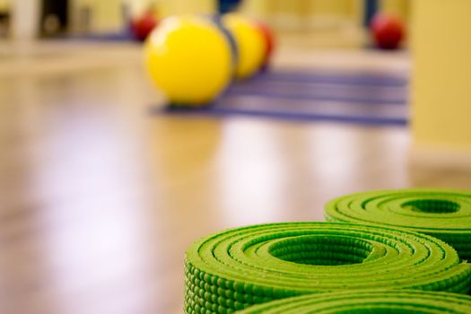 Yoga mat on wooden floor to perform meditation exercises
