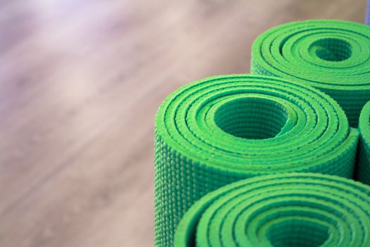 Yoga mat on wooden floor to perform meditation exercises