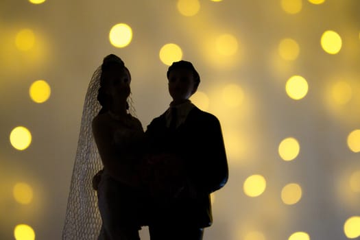 Silhouette of newlyweds on bright background