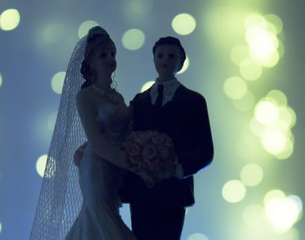 Silhouette of newlyweds on bright background