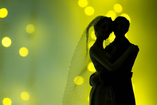 Silhouette of newlyweds on bright background