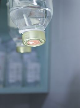 Plastic bottle of serum in surgical operation