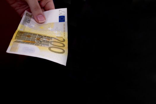 Intention to make a payment with a two hundred euro bill
