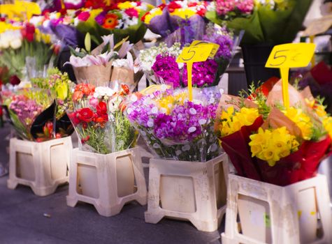 Bouquets of varied flowers on the street. Multicolor floral