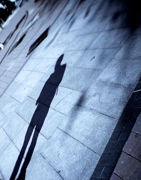 Shadow of young boy on the street floor. Tranquil scene
