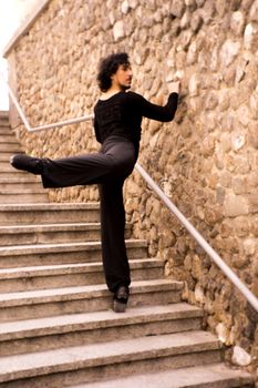 Male dancer doing a classic ballet pirouette. Urban background