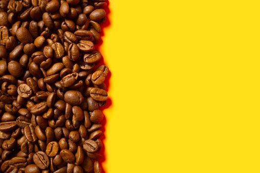 Texture of coffee beans. Roasted coffee beans background. close up Coffee beans with copy space on Orange background