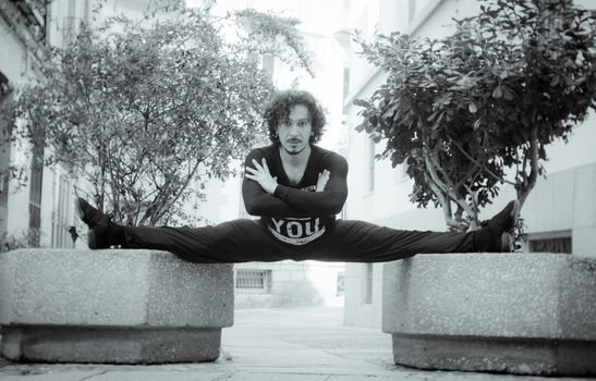 Male dancer in ballet pose. Street background