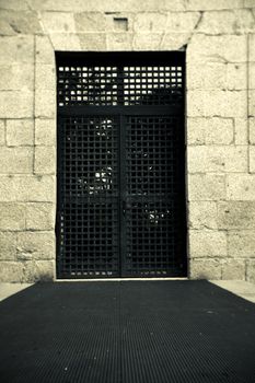 Iron gate with old squares. Entrance to the building.