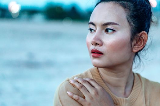 Portrait of asian woman posting and thinking with blured background