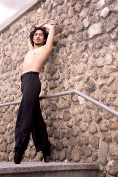 Male dancer doing a classic ballet pirouette. Urban background