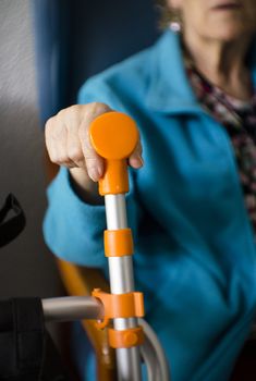 Elderly womans hand resting on her walker