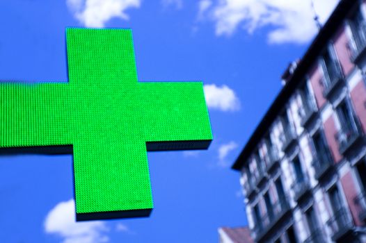 Sign in the shape of a cross indicating the existence of a pharmacy