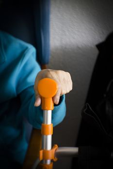 Elderly womans hand resting on her walker