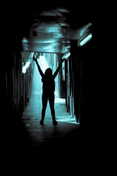 Woman alone and sad in a tunnel. Scene of mystery and desolation