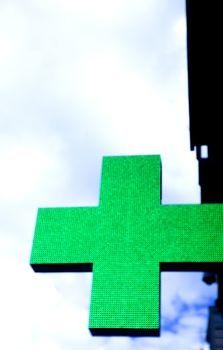 Sign in the shape of a cross indicating the existence of a pharmacy