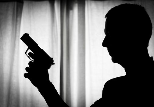 Man in a position of alert with a gun in his hand