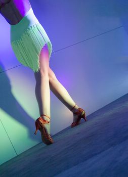 Woman with green dress dancing latin dance 