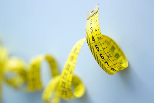 Yellow tape measure rolled. No people