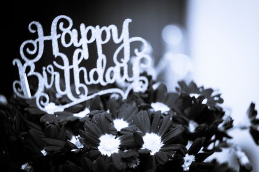 Flower arrangement with happy birthday sign