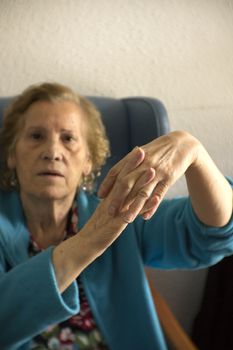 Hands of elderly woman with alzheimer doing massage