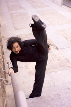 Male dancer doing a classic ballet pirouette. Urban background