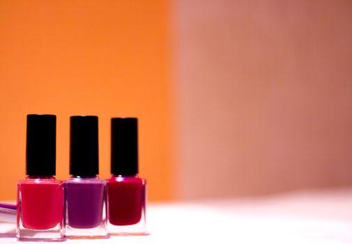 Nail polishes with strong colors. No people. Copy space
