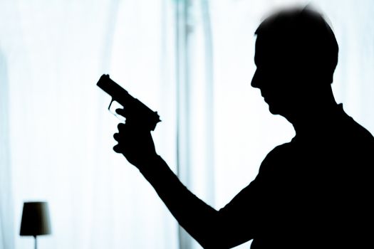 Man in a position of alert with a gun in his hand