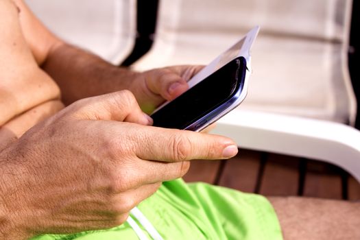 Man using a mobile phone in the holiday pool.