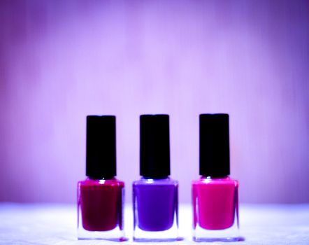 Nail polishes with strong colors. No people. Copy space