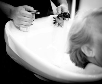 Hairdresser washing the head of a client. Hair not yet wet