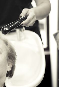 Hairdresser washing the head of a client. Hair not yet wet