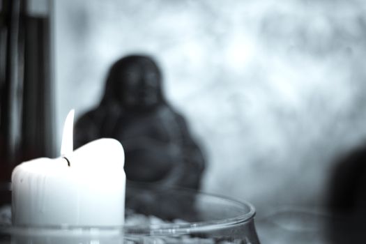 Generic buddha decoration with candle and flower. Relax scene
