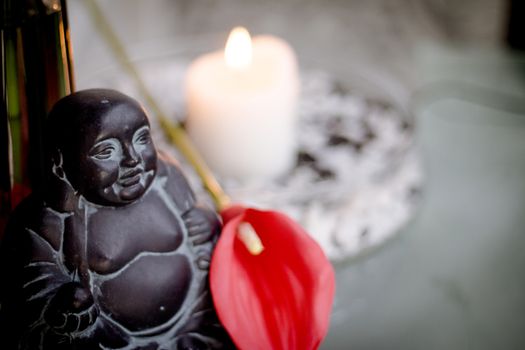 Generic buddha decoration with candle and flower. Relax scene