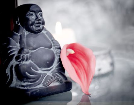 Generic buddha decoration with candle and flower. Relax scene
