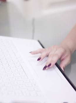 Womans hand on white computer keyboard. Copy space