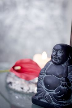 Generic buddha decoration with candle and flower. Relax scene