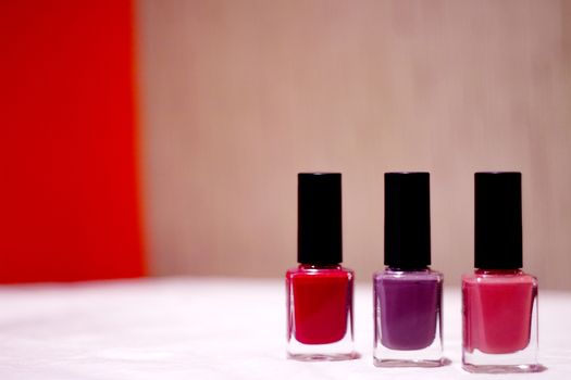 Nail polishes with strong colors. No people. Copy space