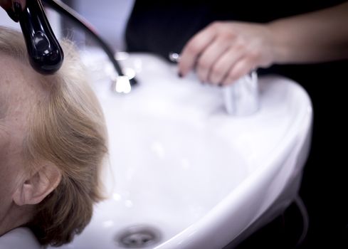 Hairdresser washing the head of a client. Hair not yet wet