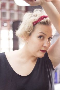 Portrait of blonde woman with short hair and pinup style. Relaxed expression