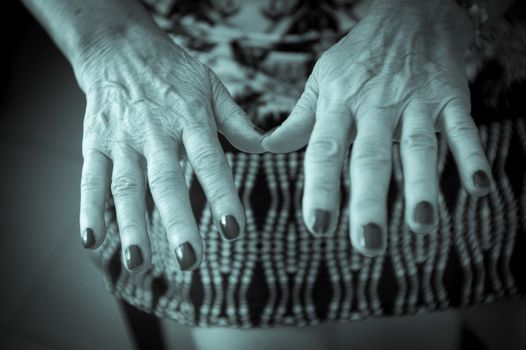 Hands of old woman and elderly caregiver