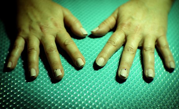 Womans hands showing semi-permanent beige manicure