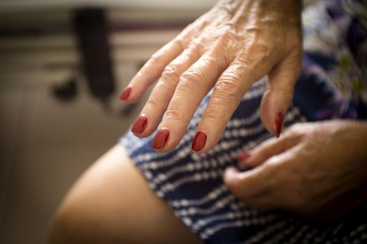 Hands of old woman and elderly caregiver