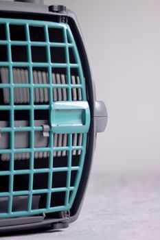 Large pet carrier with black defocused cat